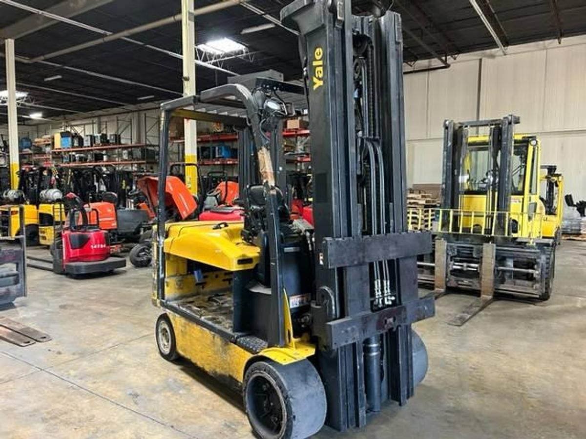 Side view of refurbished 2016 Yale ERC120VHN electric forklift showing operator cab, chassis, and triple mast during Brampton deployment