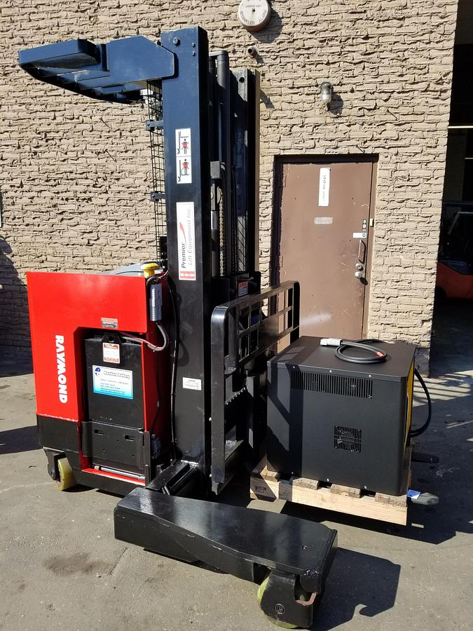 Side view of Raymond EASI 4D-R45TT multi-directional electric forklift showing triple-stage mast, cushion tires, and CSA-certified chassis – unit staged in GTHA ON