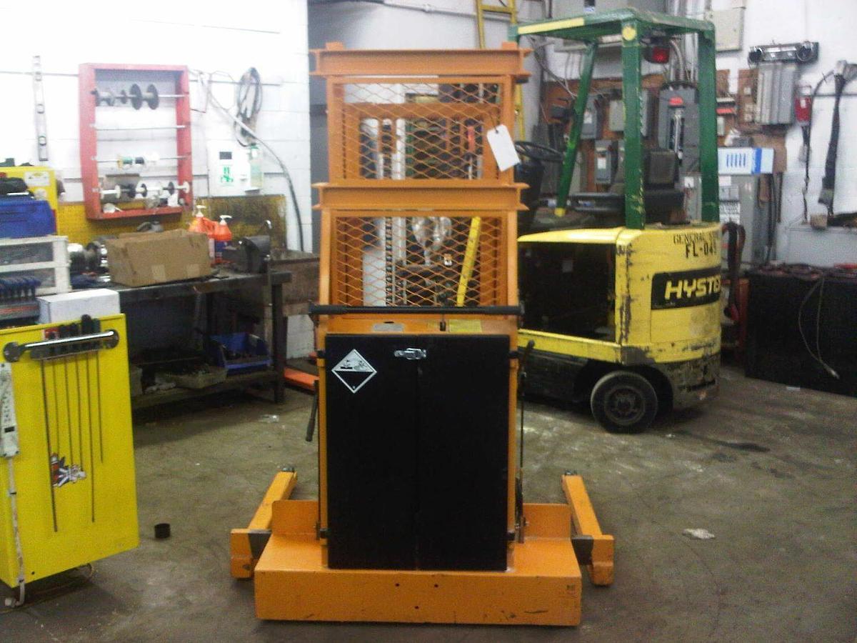 Operator compartment of refurbished 2010 Lift‑Rite T90K4024A manual push electric lift stacker showing steering handle, electric lift controls, 12 volt battery charger port, and CSA certification decal during Ontario deployment.