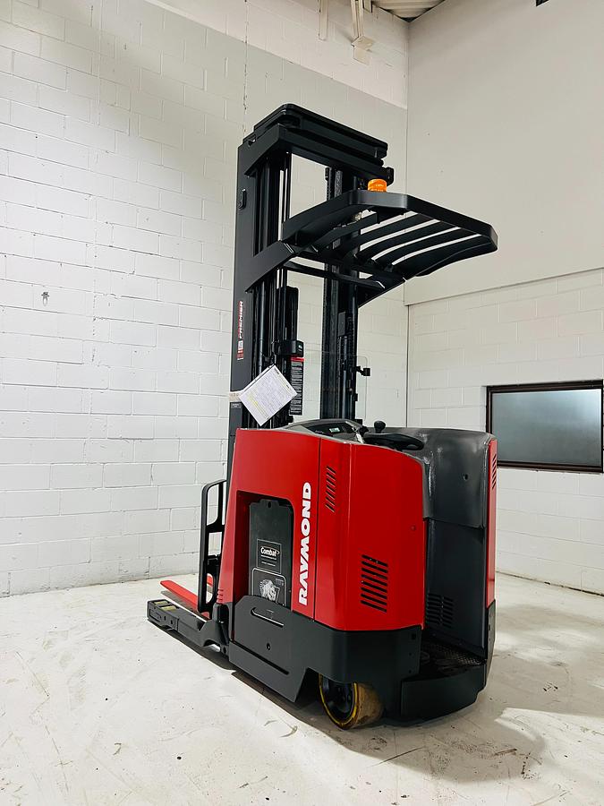 Opposite side profile of refurbished 2017 Raymond 750DR32TT electric deep-reach forklift showing 317" triple mast, reach carriage, and narrow aisle chassis during Brampton deployment