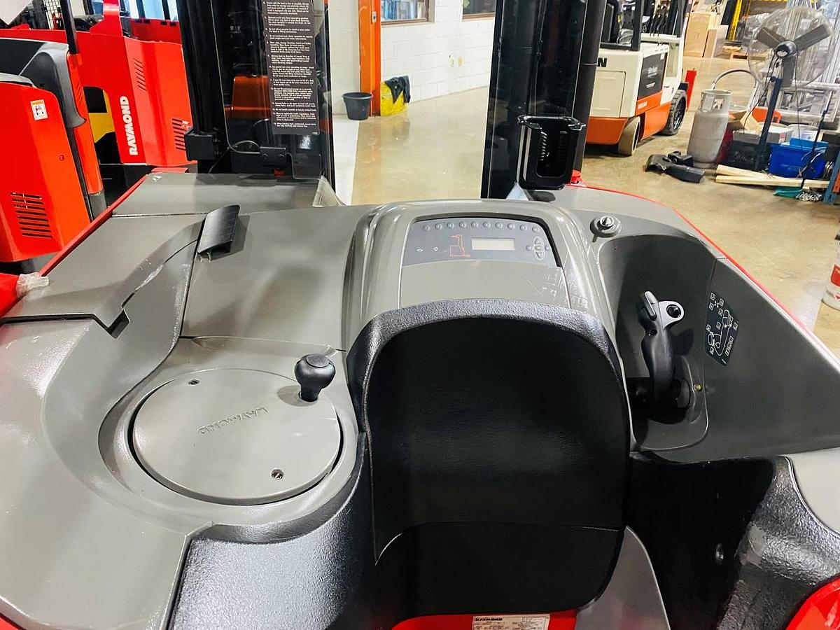 Interior view of refurbished 2021 Raymond 730-R35TT electric reach truck showing forward-facing controls, floor mat, safety rails, and CSA decals during Oakville deployment