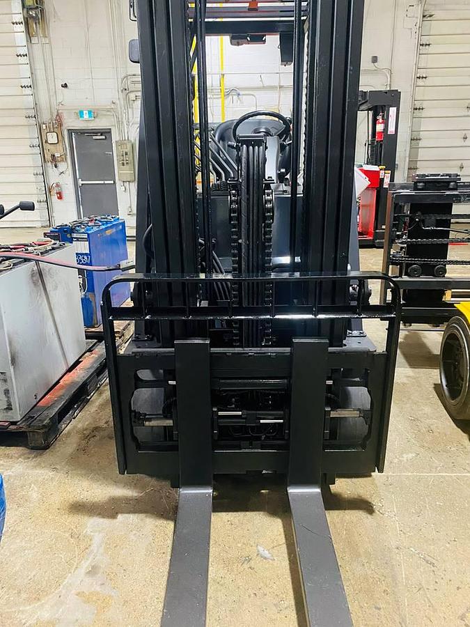 Front view of 2019 Toyota 8FBCU32 electric sit-down forklift showing triple-stage mast, 42” forks, load backrest, and CSA-certified chassis – unit staged in Brampton ON