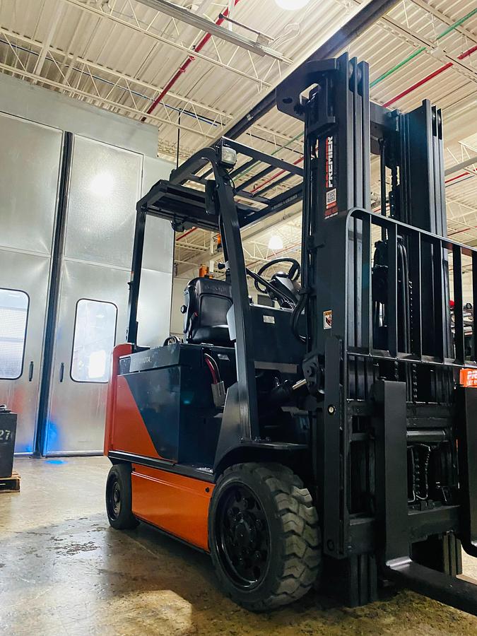 Used 2020 Toyota 8FBCU32-EE electric forklift with 187" triple mast and EE rating shown at front side angle during Brampton deployment