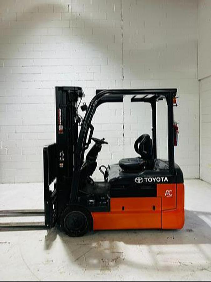Opposite side view of refurbished 2023 Toyota 8FBE20U electric forklift showing operator cab, rear chassis, freezer-compatible configuration, and non-marking cushion tires during Mississauga deployment
