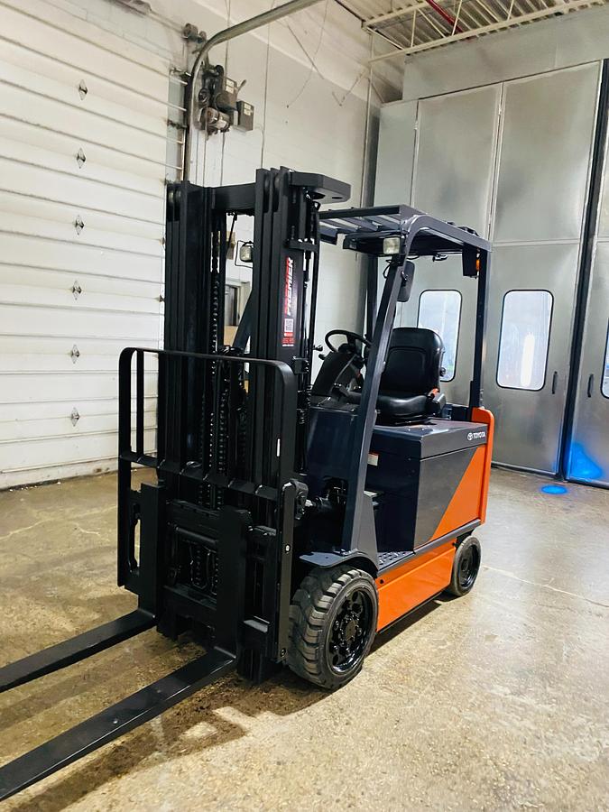 Used 2020 Toyota 8FBCU32-EE electric forklift with 187" triple mast and EE rating shown at front side angle during Brampton deployment