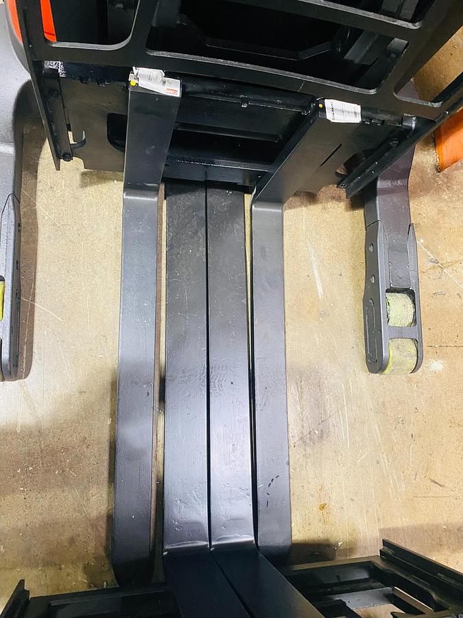 Close‑up of forks and straddle legs on Raymond 750R45TT Budget reach truck.