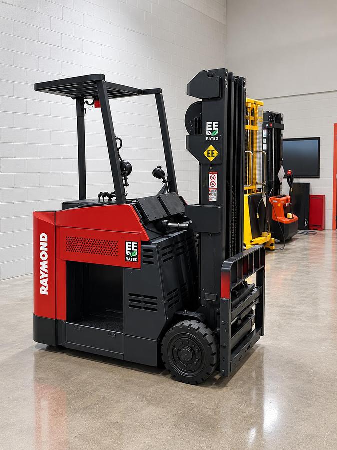 Front side‑angle view of Raymond 060C40TT EE‑rated stand‑up counterbalance — mast, carriage, and chassis