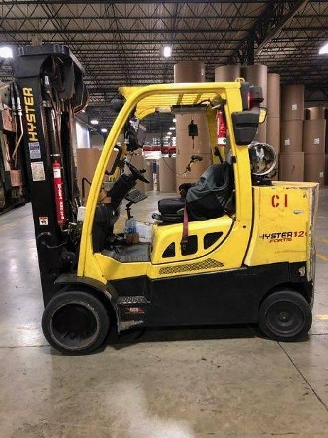 Side profile of 2014 Hyster S120FTPRS LPG cushion forklift showing mast rails, Cascade clamp arms, and chassis layout during Brampton deployment