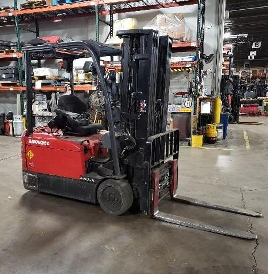 Opposite side view of Raymond 4460C40 3-wheel electric sit-down forklift shown chassis only without battery or charger – CSA-certified 4,000 lb unit featuring 240” triple mast, 42” adjustable forks with side shift, ergonomic operator compartment, and 36V AC chassis staged in Brampton ON; battery and charger available separately as extra options new or used – Premier Lift Equipment