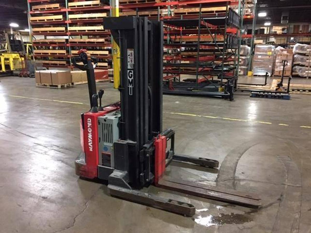 Side front view of refurbished 2008 Raymond DSS40 electric walkie straddle stacker showing mast rails, 42" forks, and CSA decal during Ontario deployment