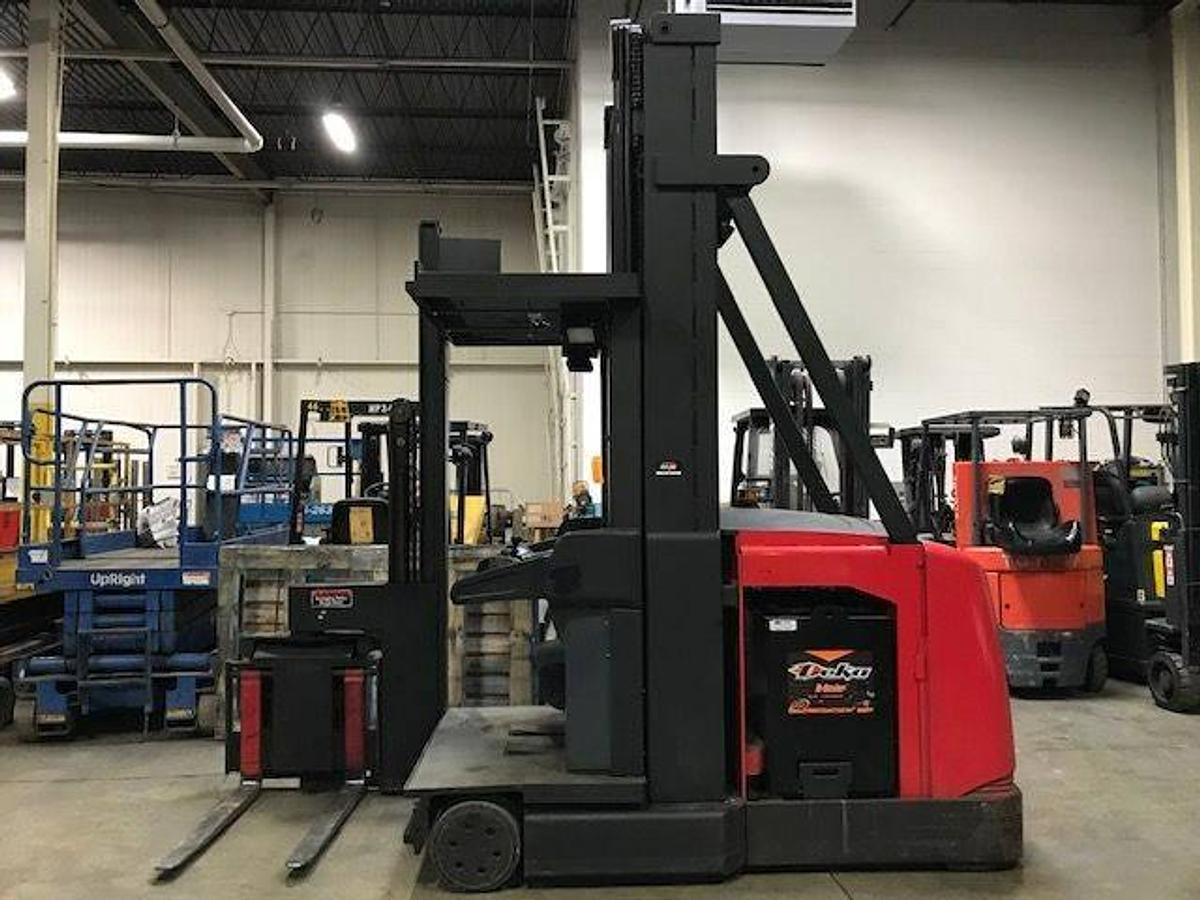 Side view of refurbished 2001 Raymond SA-CSR30TWG electric man-up turret truck showing swing reach mast, CSA decal, and 48V battery compartment during Ontario deployment