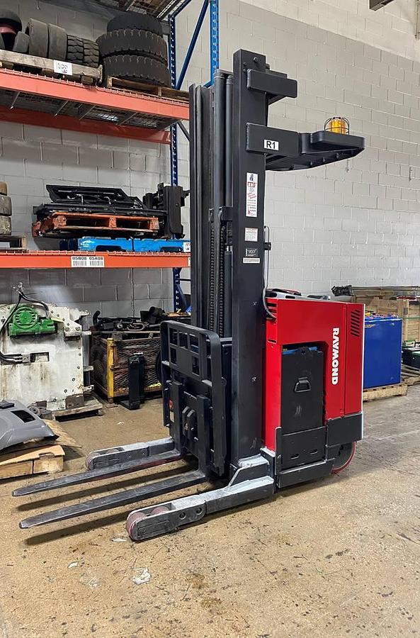 Side view of CSA-certified Raymond EASIR30TT reach truck with triple mast and cushion tires – staged in GTA ON