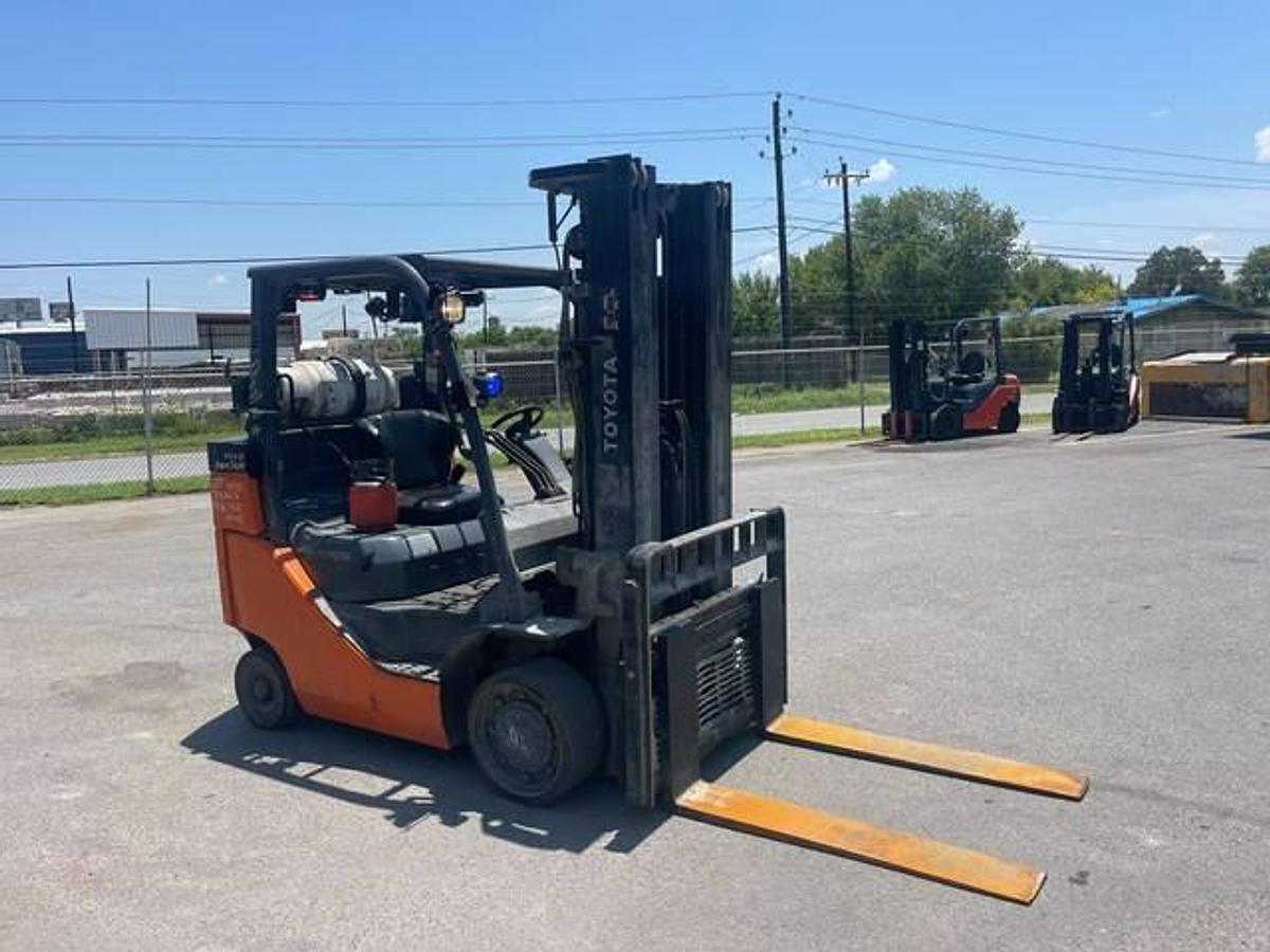 Opposite front side view of refurbished 2016 Toyota 8FGC35U-BCS LPG cushion forklift showing operator cab, solid cushion tires, side shift carriage, and mast layout during Brampton deployment