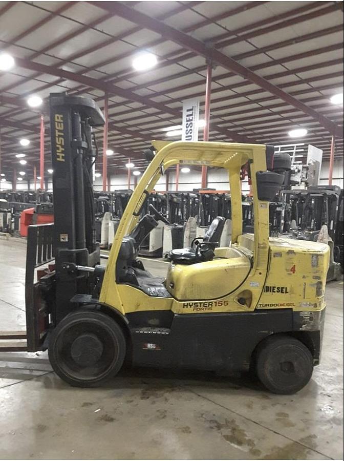 Front side angle of Hyster S155FT diesel cushion forklift showing 2-stage mast, fork positioner, 60" forks, and operator cab during Brampton deployment