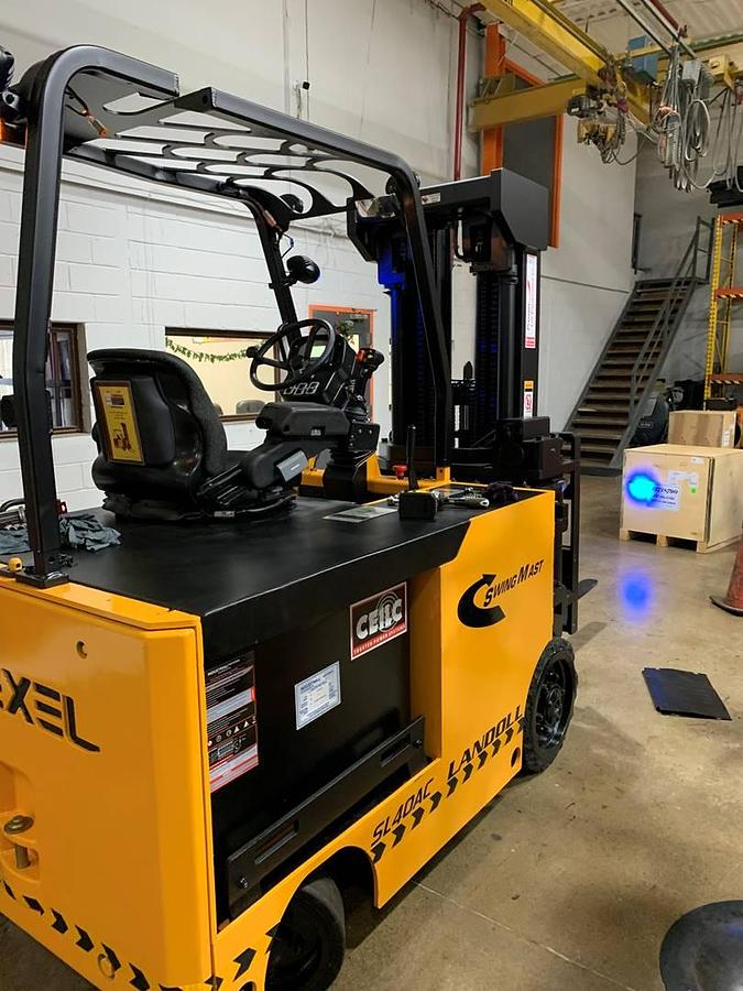 Rear side angle of Drexel SL-40AC SwingMast forklift showing counterweight, rear wheels, and chassis profile with CSA certification during Brampton deployment