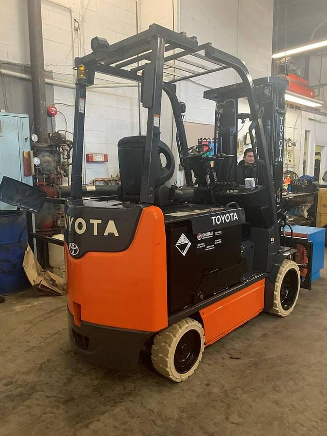 Rear side angle of 2016 Toyota 8FBCU30 electric forklift – CSA-ready 6,000 lb chassis with overhead guard, rear counterweight, and cushion tires shown reconditioned with new 48V battery upgrade available in Brampton ON – Premier Lift Equipment