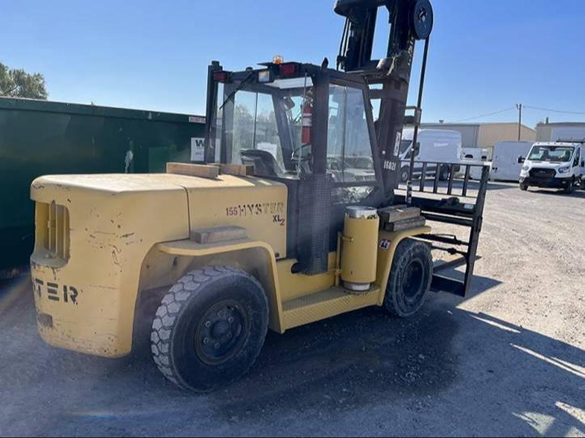 Rear side view of refurbished 2007 Hyster H155XL2 LP Gas forklift showing rear chassis, solid pneumatic tires, and safety lighting during Ontario deployment.