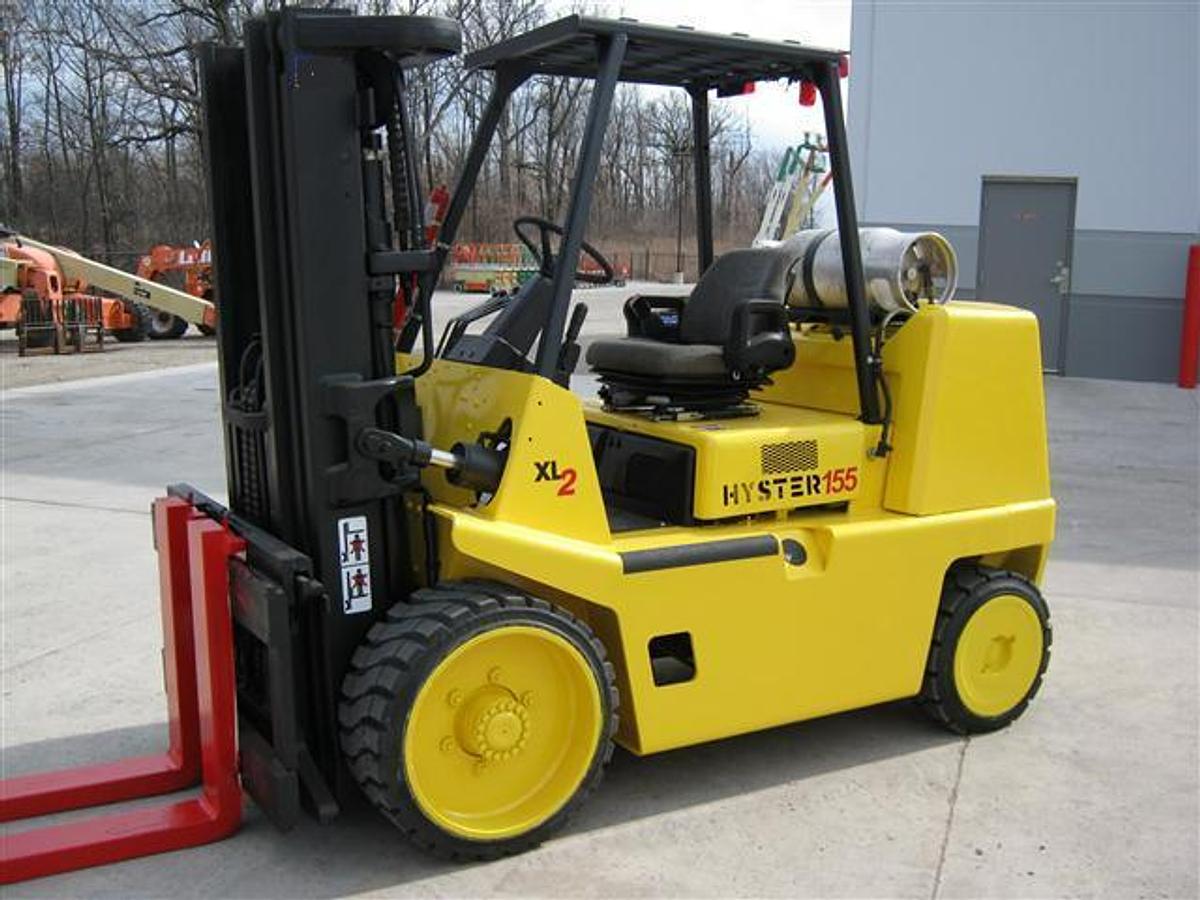High-capacity cushion tire forklift (15,000 lb+), LPG or diesel powered, CSA-certified, solid non-marking tires, indoor warehouse use, heavy-duty mast, enclosed cab, overhead guard.
