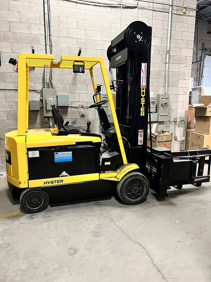 Side view of refurbished Hyster N30XMH electric man‑down turret truck showing Superior Swing Mast, turret carriage, cushion tires, and CSA certification decal during Ontario deployment.