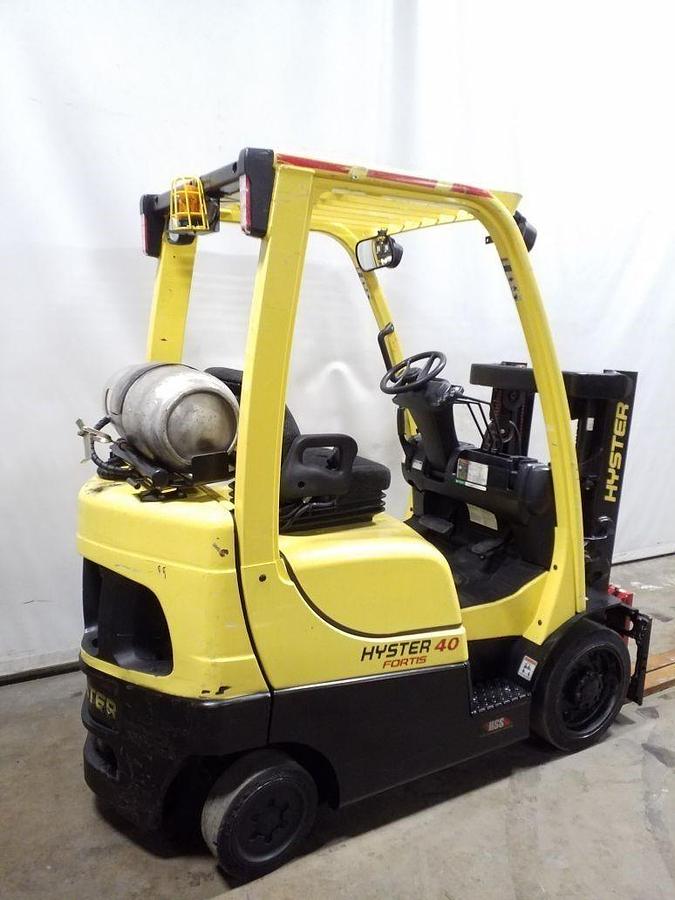 Rear side view of refurbished 2014 Hyster S40FT LP Gas forklift showing rear chassis, solid tires, truckers mast with side shift, and CSA certification decal during Ontario deployment.