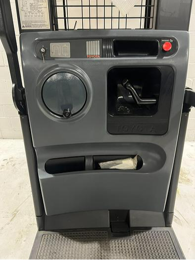 Operator compartment of Budget Toyota 7BPUE15 order picker showing platform, controls, and guard rails.
