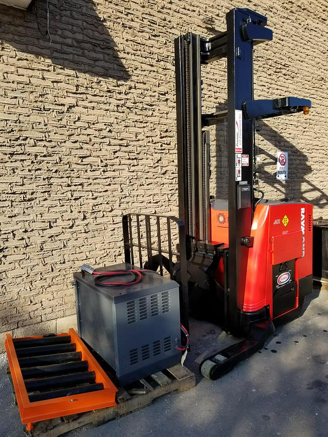 Refurbished 2011 Raymond 740 R45TT electric reach truck with 189" triple mast and CSA decals shown at front side angle during Brampton deployment