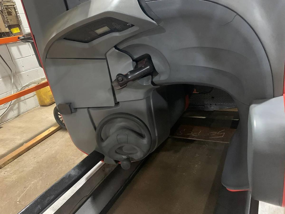 Interior view of refurbished 2019 Raymond 772-R45TT electric reach truck showing side stance controls, floor mat, safety rails, and CSA decals during Toronto deployment