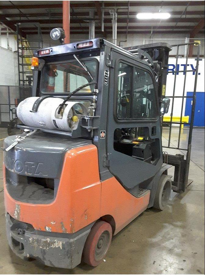 Rear view of refurbished 2011 Toyota 8FGCU32 LP gas forklift showing counterweight, propane tank mount, and CSA inspection tag during Brampton deployment