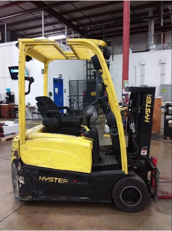Side view of refurbished 2012 Hyster J40XNT 3‑wheel electric forklift showing truckers mast, 42" forks, side shift, cushion tires, and CSA certification decal during Ontario deployment.
