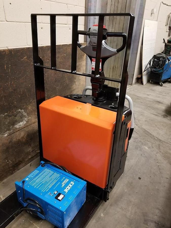 Front view of refurbished 2011 BT LPE200/8 electric walkie/rider pallet jack showing 27" x 45" forks, flip‑down operator platform, and CSA certification decal during Ontario deployment.