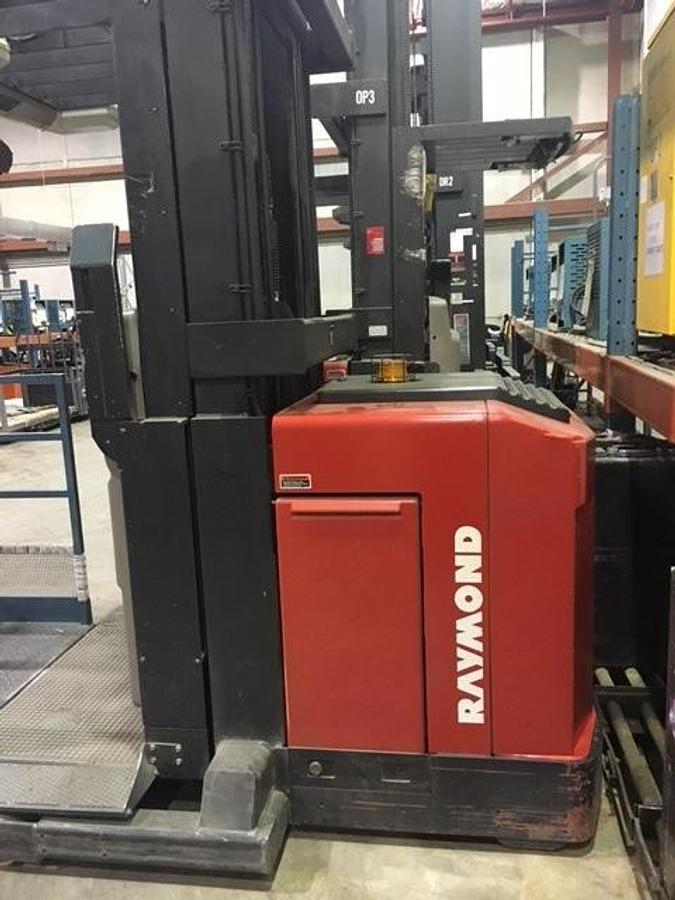 Side view of refurbished 1997 Raymond EASIOPC30TT electric order picker showing battery compartment, chassis frame, and high-picking platform during Concord deployment