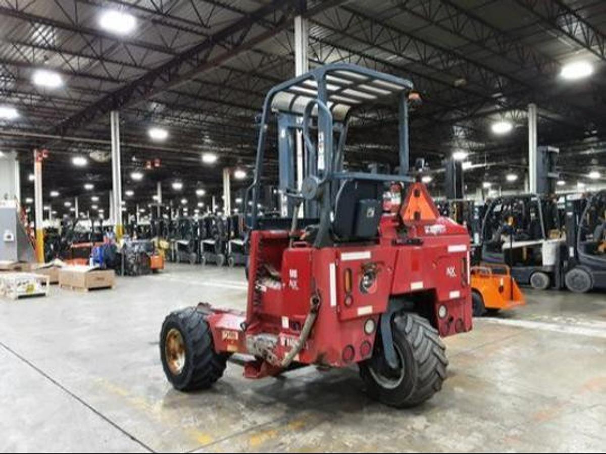 Angled back side view of Moffett M8 55.3NX truck-mounted diesel forklift showing counterweight, rear tire configuration, operator cab, and CSA-certified chassis – unit staged in Brampton ON