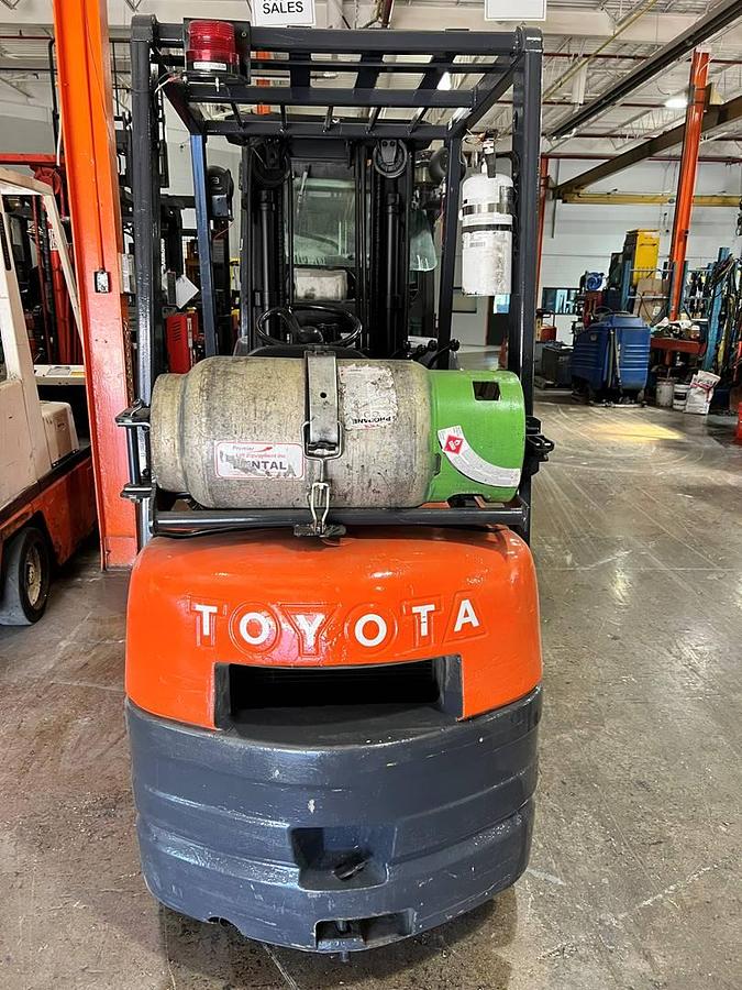 Rear view of refurbished 2000 Toyota 42-6FGCU15 LP gas forklift showing counterweight, propane tank mount, and CSA inspection tag during Brampton deployment