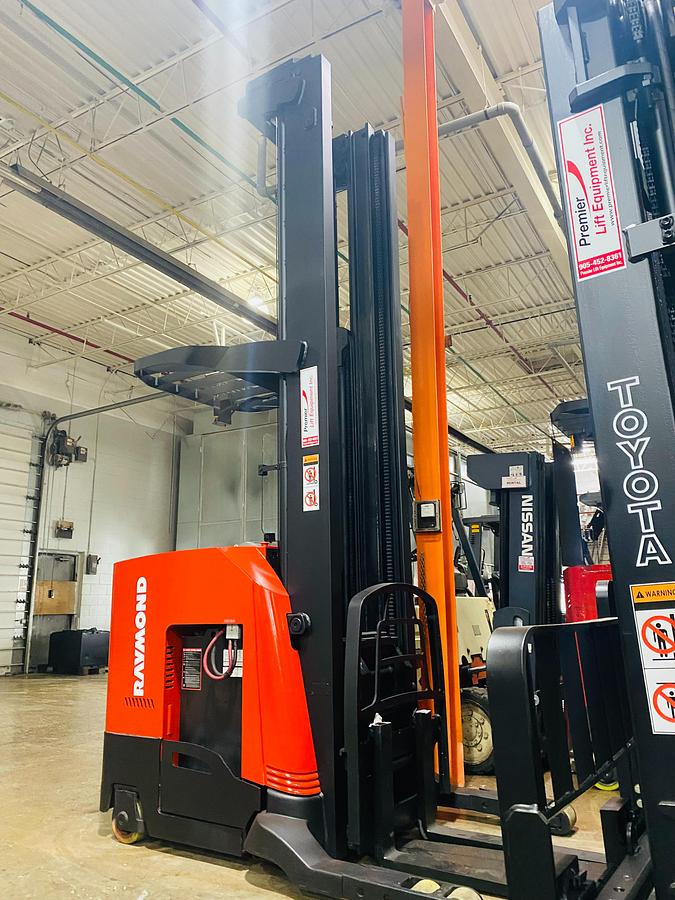 Front view of Raymond 750R45TT Budget reach truck — mast, carriage, and poly tires.
