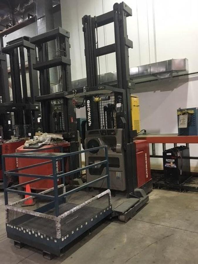 Front angle view of refurbished 1997 Raymond EASIOPC30TT electric order picker showing mast, forks, platform rails, and CSA inspection tag during Concord deployment