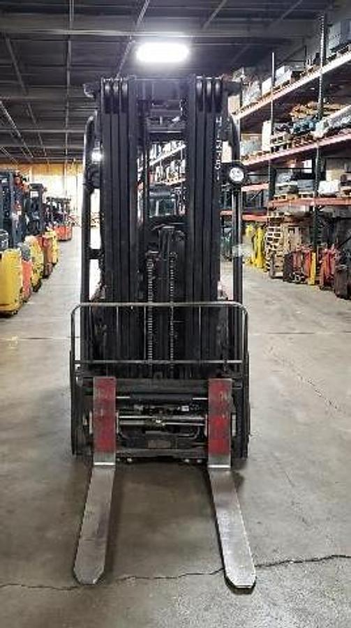 Front view of Raymond 4460C40 3-wheel electric sit-down forklift with CSA certification – 4,000 lb capacity unit featuring 240” triple mast, 42” adjustable forks, side shift carriage, UL/EE fire-safe rating, and non-marking cushion tires; shown chassis only without battery or charger, available separately as extra options new or used – Premier Lift Equipment