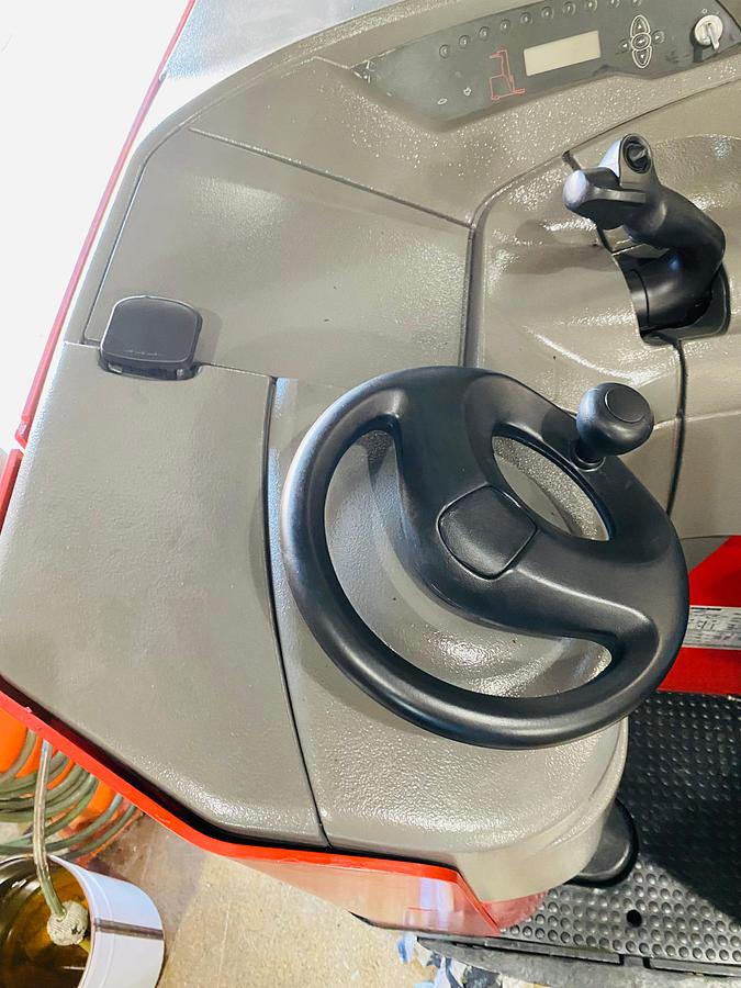 Operator compartment view showing stand-up controls and ergonomic steering and Joystick handle