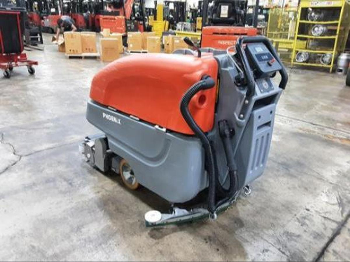 Rear angle view of 2023 PowerBoss Phoenix 26 floor scrubber showing traction drive and recovery tank