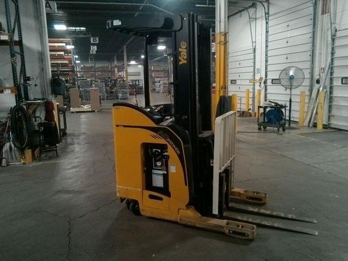 Side view of refurbished 2012 Yale NR040EA electric reach truck showing mast rails, CSA decal, and 42" forks during Ontario deployment
