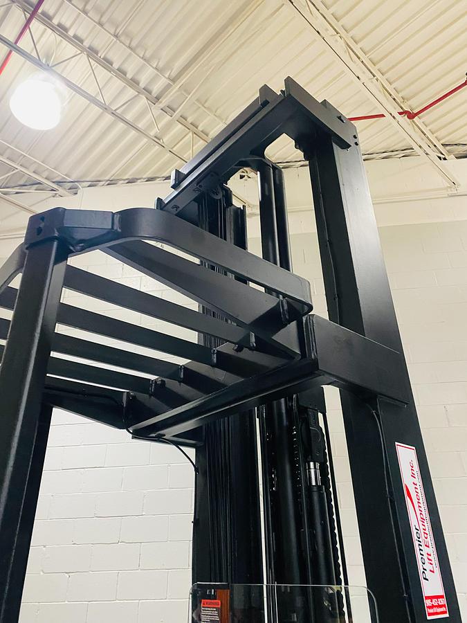 Overhead guard and top of mast channel — protective canopy and upper mast rails