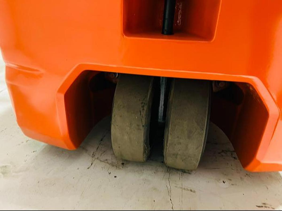 Underside angle showing 3-wheel layout of refurbished 2023 Toyota 8FBE20U electric forklift with dual drive tires and single rear caster during Mississauga deployment