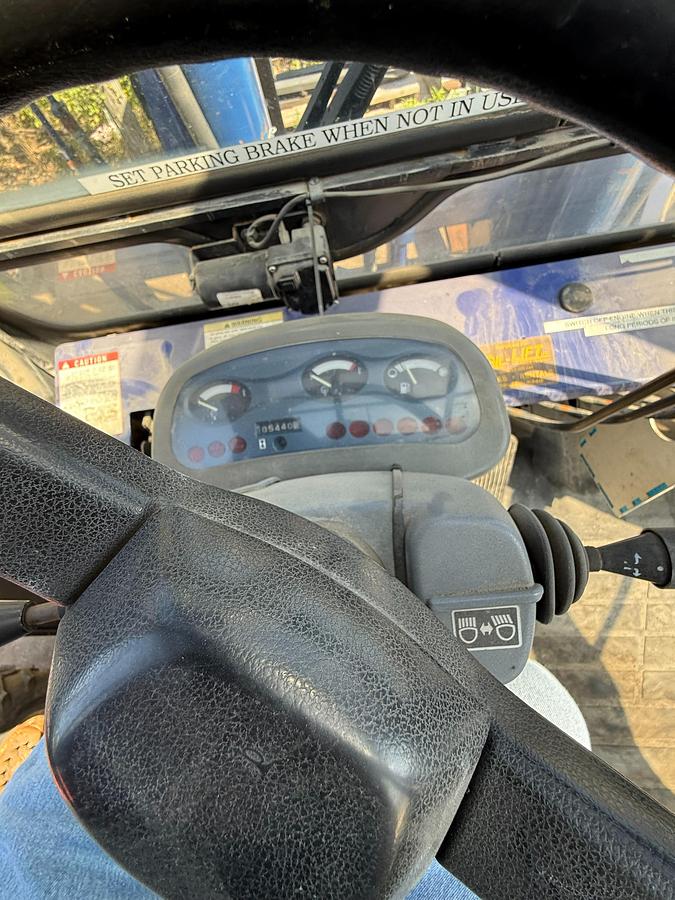 Komatsu FD135T‑6 forklift operator dash with gauges, controls and cab layout