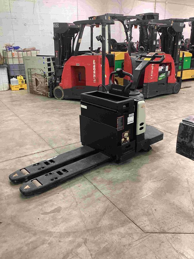 Side view of Crown PE4500 rider pallet truck with rare 22-inch narrow forks and 48-inch fork length, low-hour unit.