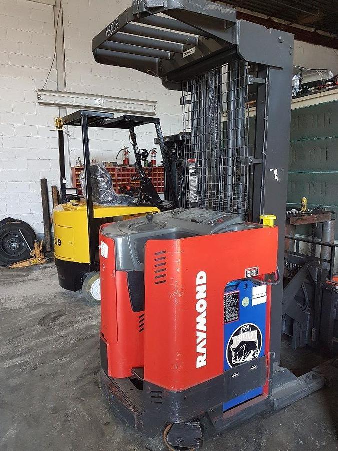 Rear side view of refurbished 1998 Raymond EASIR40TT electric reach truck showing counterweight, rear chassis panel, and drive unit cover during Mississauga deployment