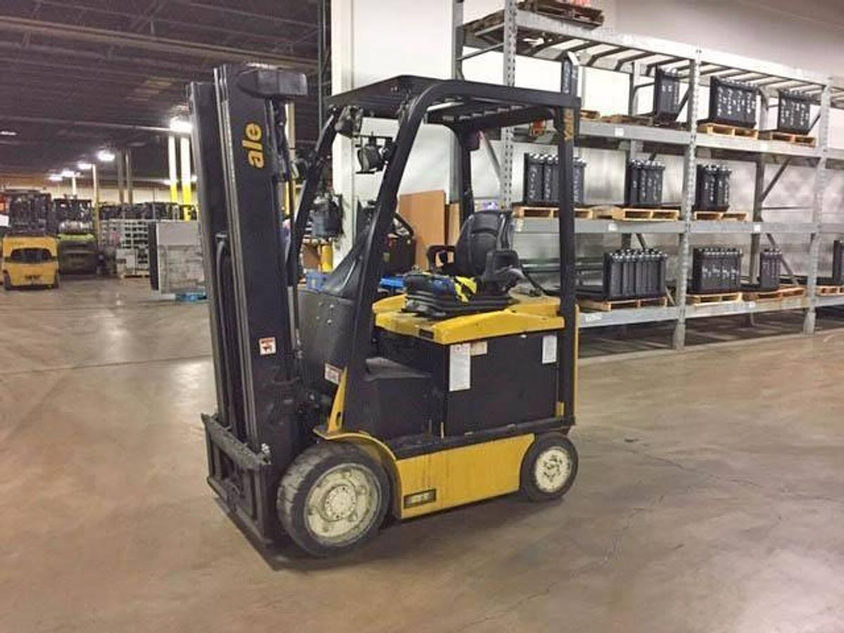 Opposite front side view of refurbished 2016 Yale ERC050VGN electric forklift showing mast, forks, operator cab, and solid tire chassis during Brampton deployment