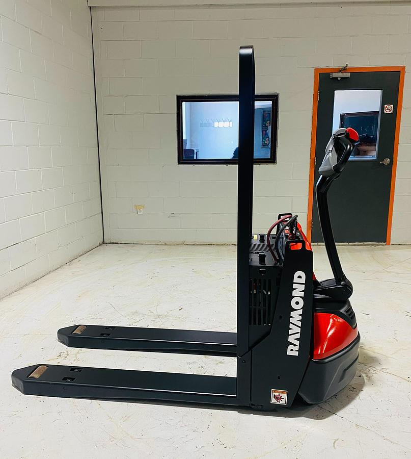 Side profile of 2020 Raymond 8210 walkie pallet jack with short 27x34 forks.