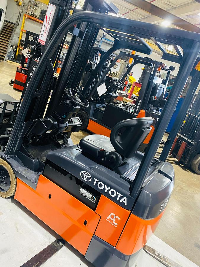 Rear side angle view of 2022 Toyota 8FBE20U electric forklift showing counterweight, operator cab, and CSA decal with freezer-compatible chassis during Brampton deployment