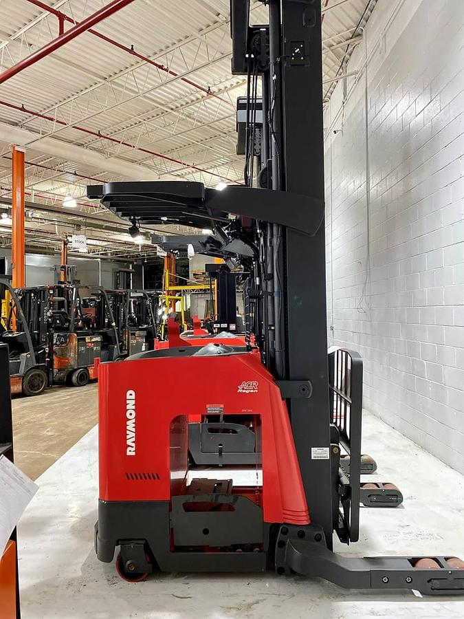 Side profile of Raymond 752DR32TT electric deep-reach forklift showing extended mast rails, reach mechanism, and chassis layout during Brampton deployment