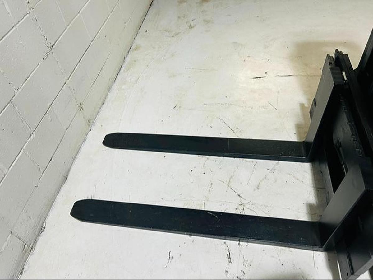 “Forks on Budget Caterpillar FC40 older electric forklift, non‑CSA, 42-inch pallet forks.