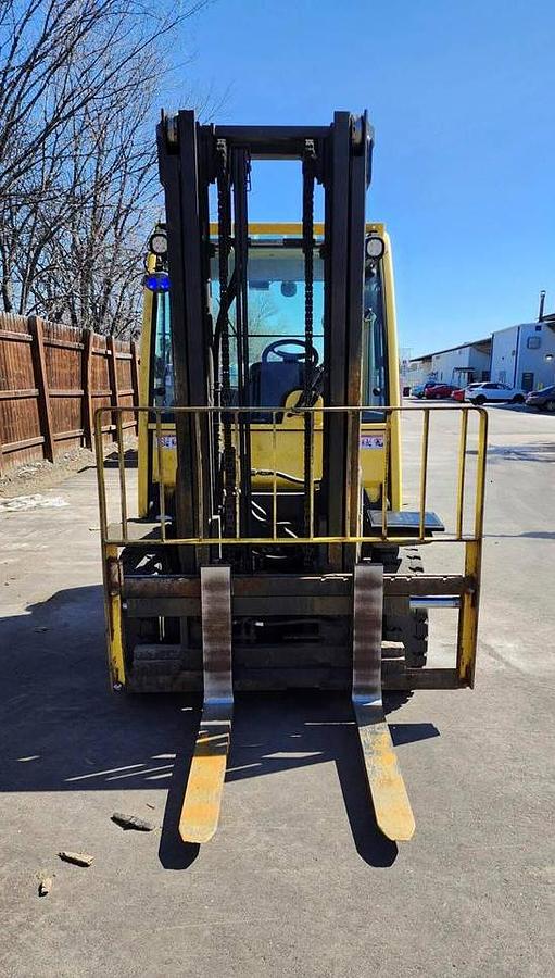Front view of refurbished 2017 Hyster H80FT LP Gas forklift showing full cab operator comfort, 2‑stage mast with side shift, solid pneumatic tires, and CSA certification decal during Ontario deployment.